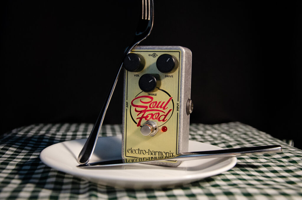 Guitar effects pedal on a plate with utensils