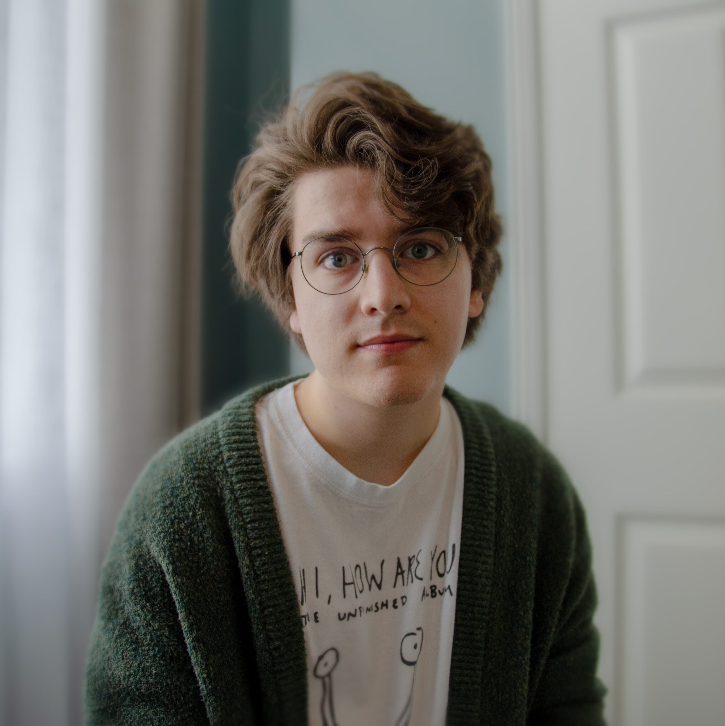 Portrait of a young man in window lit room